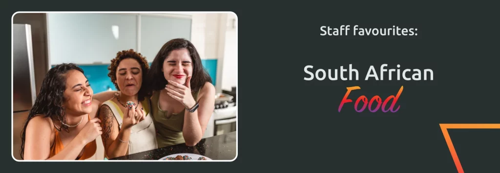 Three women enjoying South African food together in a kitchen.